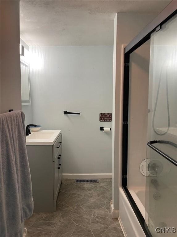 207 E Elm St, Oneida-Inside, NY 13421 - bathroom featuring vanity, tub / shower combination, and baseboards