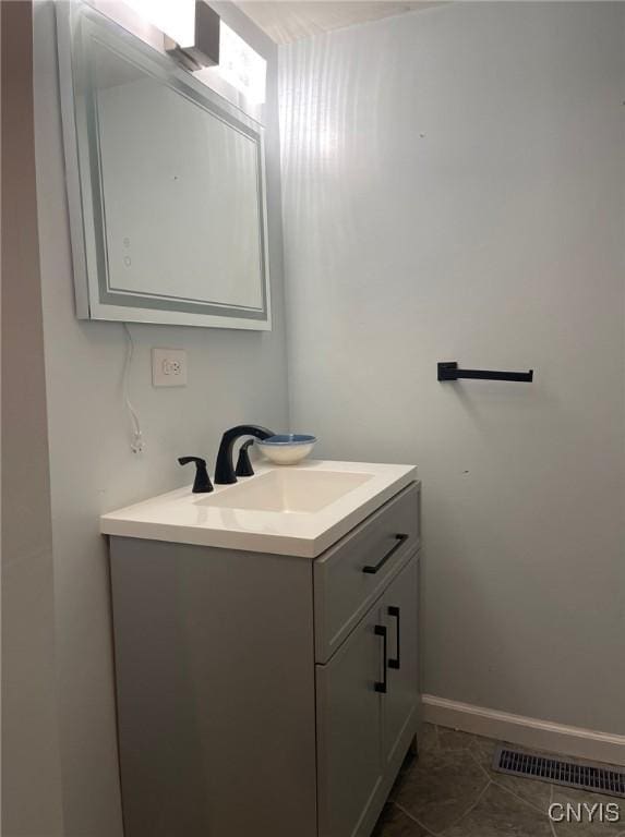 207 E Elm St, Oneida-Inside, NY 13421 - bathroom with vanity, tile patterned flooring, and baseboards
