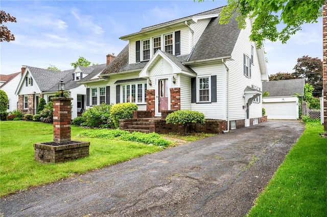 377 Winfield Rd, Irondequoit, NY 14622 - view of front facade featuring a front yard, a shingled roof, a chimney, an outdoor structure, and a detached garage