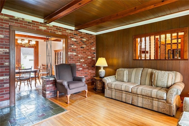 377 Winfield Rd, Irondequoit, NY 14622 - living room featuring a chandelier, wood walls, wood ceiling with exposed beams, brick wall, and wood finished floors