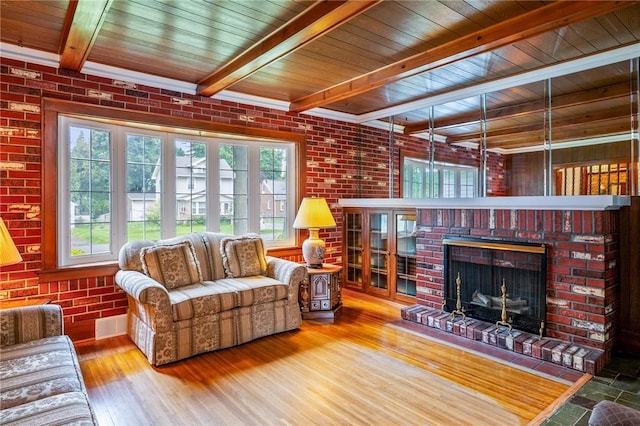 377 Winfield Rd, Irondequoit, NY 14622 - living area with wooden ceiling with exposed beams, wood finished floors, a brick fireplace, and brick wall