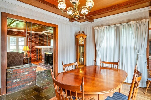 377 Winfield Rd, Irondequoit, NY 14622 - dining area featuring a chandelier, a brick fireplace, and crown molding