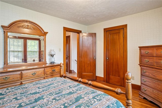 377 Winfield Rd, Irondequoit, NY 14622 - bedroom with wood finished floors, a textured ceiling, and baseboards
