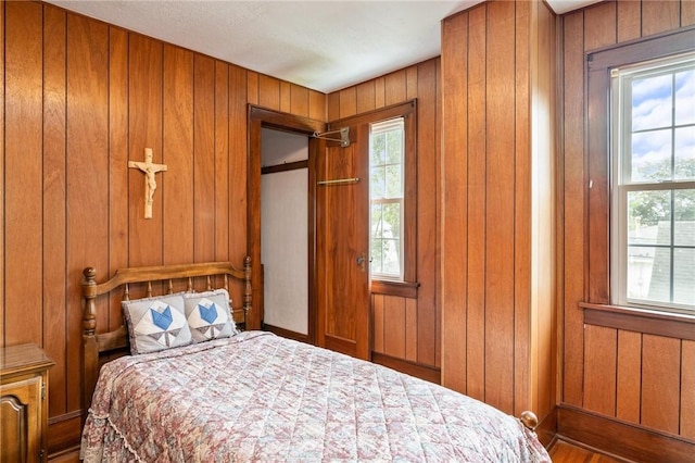 377 Winfield Rd, Irondequoit, NY 14622 - bedroom featuring wooden walls, baseboards, and wood finished floors