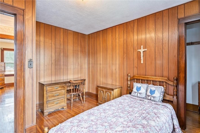 377 Winfield Rd, Irondequoit, NY 14622 - bedroom with wood finished floors, baseboards, a textured ceiling, and wooden walls