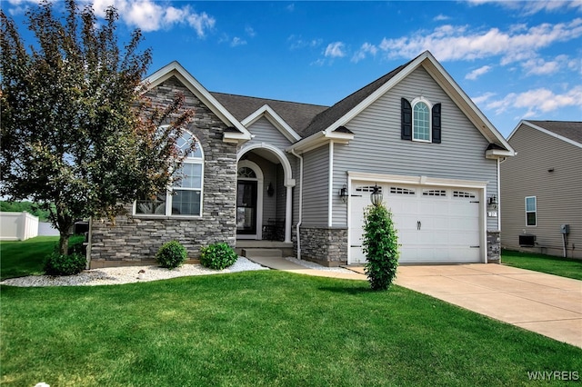 27 Skylark Ln, Wheatfield, NY 14304 - traditional-style house with stone siding, driveway, a front yard, and an attached garage