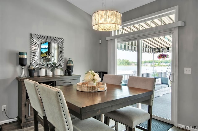 27 Skylark Ln, Wheatfield, NY 14304 - dining space featuring a chandelier, baseboards, and wood finished floors