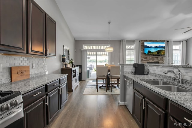 27 Skylark Ln, Wheatfield, NY 14304 - kitchen featuring a sink, stainless steel appliances, tasteful backsplash, light stone counters, and light wood finished floors