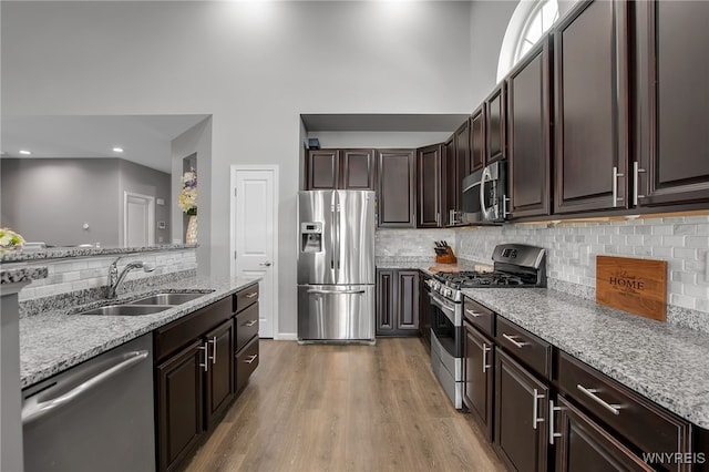 27 Skylark Ln, Wheatfield, NY 14304 - kitchen with stainless steel appliances, a sink, backsplash, light wood finished floors, and recessed lighting
