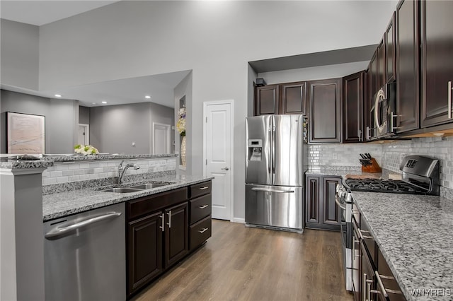 27 Skylark Ln, Wheatfield, NY 14304 - kitchen featuring stainless steel appliances, a sink, backsplash, wood finished floors, and light stone counters