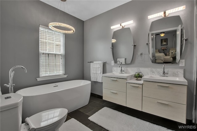27 Skylark Ln, Wheatfield, NY 14304 - full bath with double vanity, a soaking tub, toilet, ceiling fan, and connected bathroom