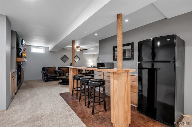27 Skylark Ln, Wheatfield, NY 14304 - kitchen featuring freestanding refrigerator, a breakfast bar area, butcher block counters, open floor plan, and dark carpet