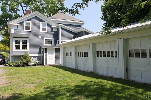 42 Mechanic St, Elbridge, NY 13080 - view of property exterior with a chimney, a lawn, an outbuilding, board and batten siding, and a shingled roof