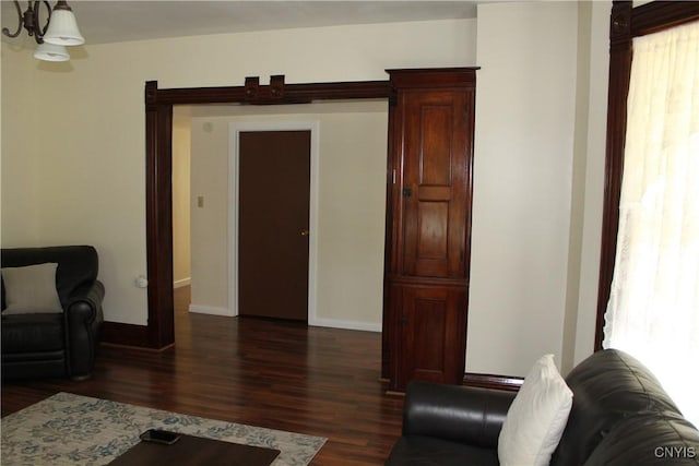 42 Mechanic St, Elbridge, NY 13080 - living area with dark wood finished floors, a chandelier, and baseboards