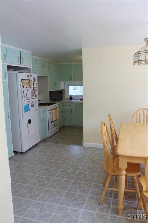 42 Mechanic St, Elbridge, NY 13080 - kitchen featuring white appliances, green cabinetry, light countertops, and baseboards