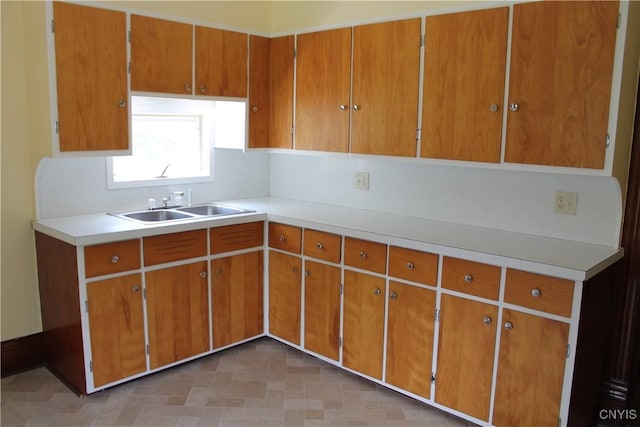 42 Mechanic St, Elbridge, NY 13080 - kitchen featuring a sink, light countertops, and brown cabinets