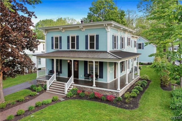 149 E Genesee St, Skaneateles, NY 13152 - italianate-style house featuring a porch, a front lawn, and metal roof