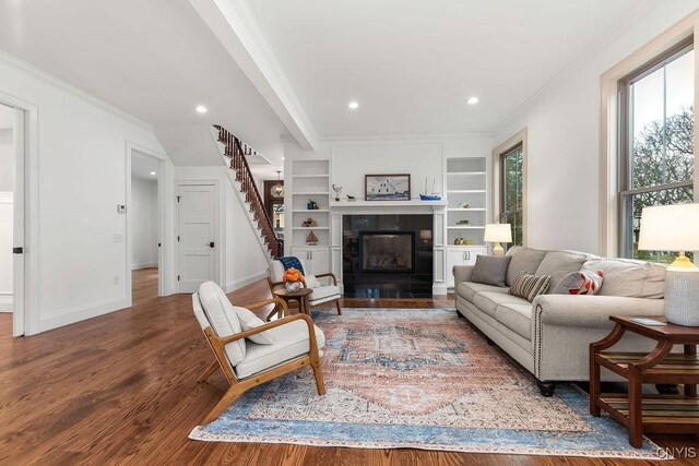 149 E Genesee St, Skaneateles, NY 13152 - living room with wood finished floors, ornamental molding, stairway, recessed lighting, and a fireplace