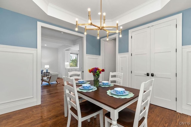 149 E Genesee St, Skaneateles, NY 13152 - dining area with a wainscoted wall, a chandelier, ornamental molding, wood finished floors, and a decorative wall