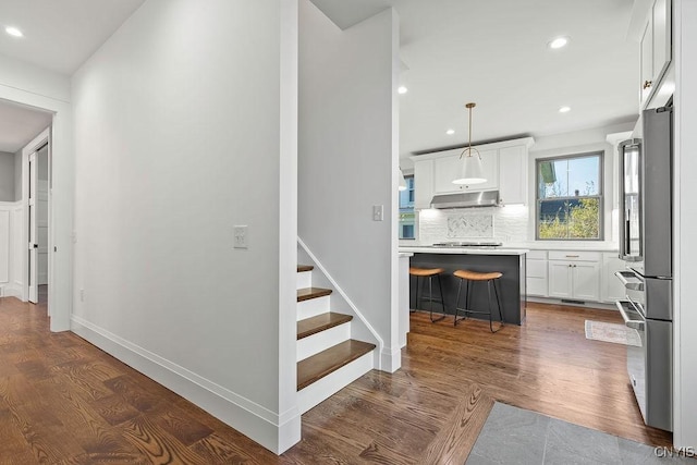 149 E Genesee St, Skaneateles, NY 13152 - hallway featuring recessed lighting, stairs, dark wood-style floors, and baseboards