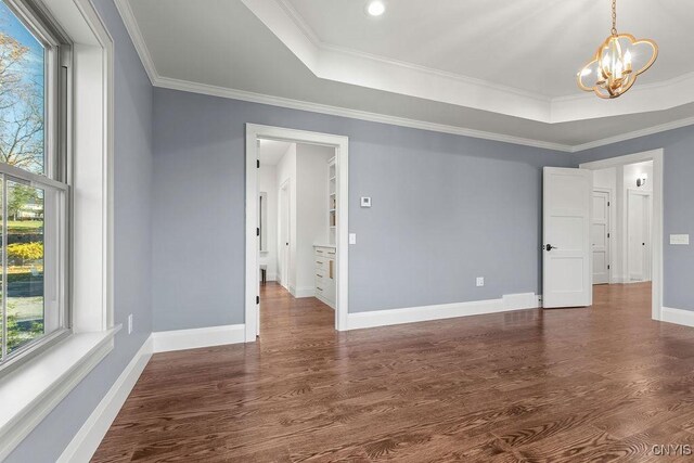 149 E Genesee St, Skaneateles, NY 13152 - unfurnished room with a chandelier, wood finished floors, baseboards, a raised ceiling, and ornamental molding
