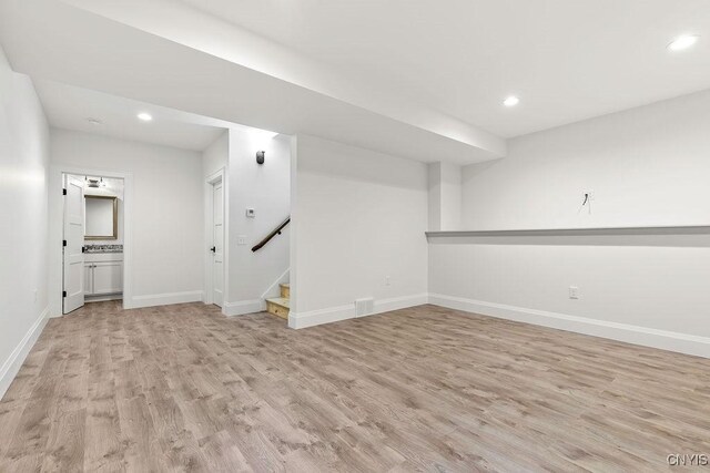 149 E Genesee St, Skaneateles, NY 13152 - finished basement featuring light wood-style floors, baseboards, recessed lighting, and stairway
