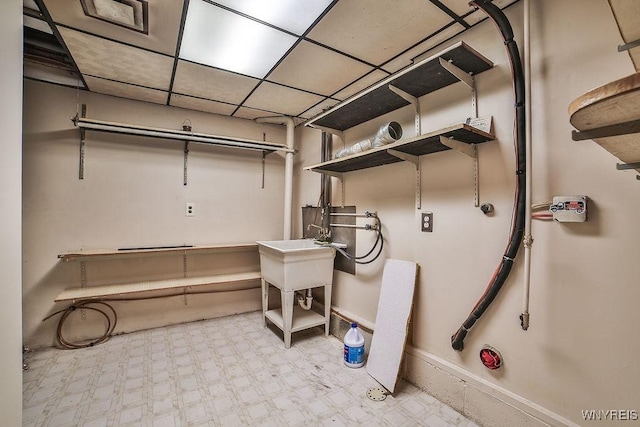831 W Gebhard Ln, Alden, NY 14004 - basement with tile patterned floors, a paneled ceiling, baseboards, and a sink