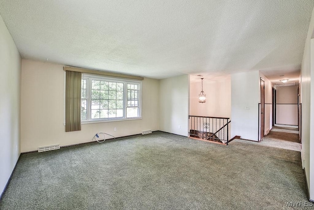 831 W Gebhard Ln, Alden, NY 14004 - carpeted empty room featuring a textured ceiling and a chandelier