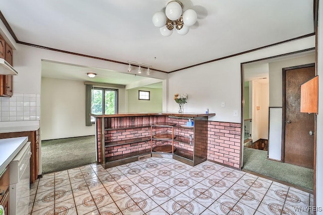 831 W Gebhard Ln, Alden, NY 14004 - kitchen featuring light carpet, track lighting, a chandelier, light tile patterned floors, and crown molding