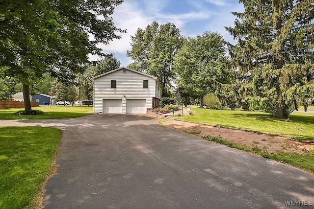 831 W Gebhard Ln, Alden, NY 14004 - view of side of home with driveway, a garage, a yard, and view of scattered trees