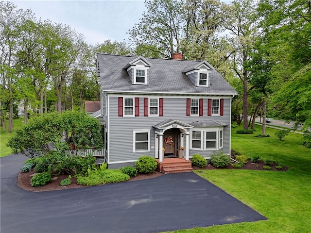 2550 E Ave, Brighton, NY 14610 - view of front of property with a chimney, a front yard, and view of wooded area