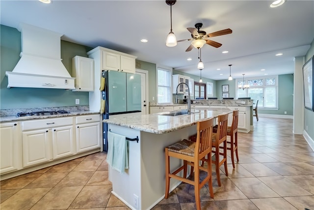 2550 E Ave, Brighton, NY 14610 - kitchen featuring custom range hood, white gas stovetop, ceiling fan, a kitchen island with sink, and recessed lighting