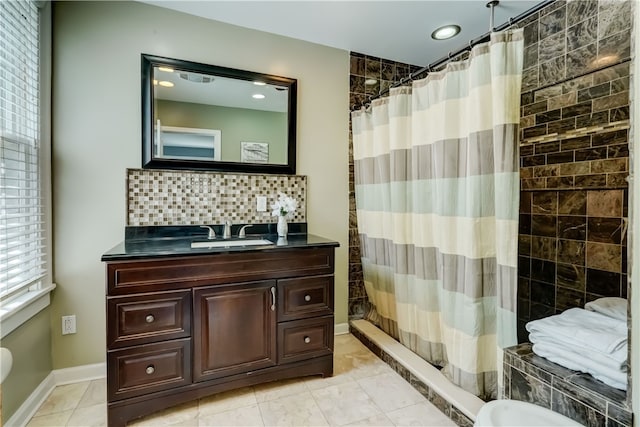 2550 E Ave, Brighton, NY 14610 - bathroom featuring curtained shower, vanity, backsplash, and recessed lighting