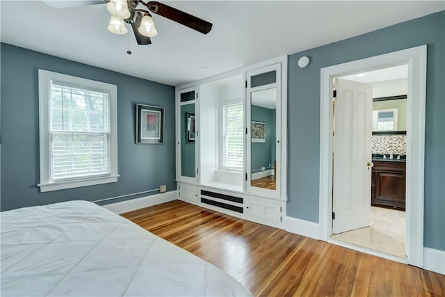 2550 E Ave, Brighton, NY 14610 - bedroom with wood finished floors, multiple windows, and ceiling fan