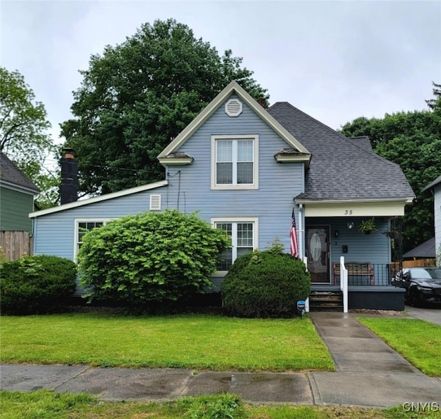 35 N 4th Ave, German Flatts, NY 13357 - view of front of house featuring a porch, a front lawn, and a shingled roof