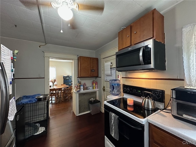 35 N 4th Ave, German Flatts, NY 13357 - kitchen with appliances with stainless steel finishes, brown cabinets, ceiling fan, and dark wood-style floors