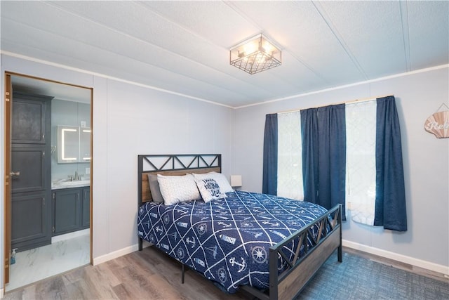 7848 Cold Springs Rd, Urbana, NY 14810 - bedroom with a sink, baseboards, wood finished floors, and connected bathroom