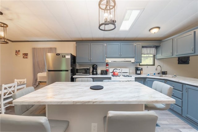 7848 Cold Springs Rd, Urbana, NY 14810 - kitchen featuring appliances with stainless steel finishes, extractor fan, a sink, and a breakfast bar