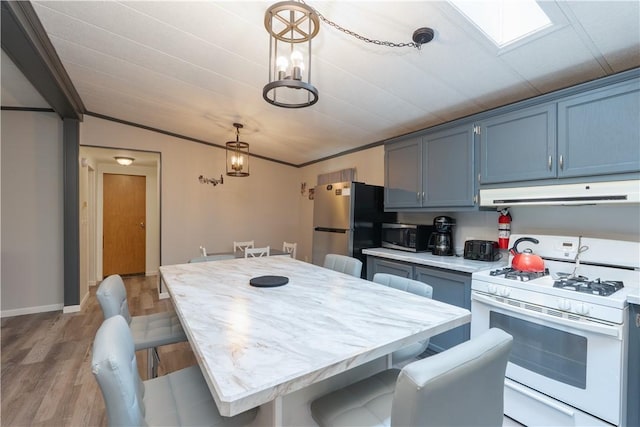 7848 Cold Springs Rd, Urbana, NY 14810 - kitchen featuring appliances with stainless steel finishes, ventilation hood, light countertops, light wood finished floors, and blue cabinetry