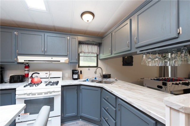 7848 Cold Springs Rd, Urbana, NY 14810 - kitchen with gas range gas stove, a sink, ventilation hood, light countertops, and blue cabinetry