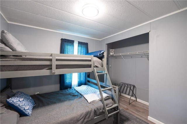 7848 Cold Springs Rd, Urbana, NY 14810 - bedroom featuring wood finished floors, a closet, and baseboards