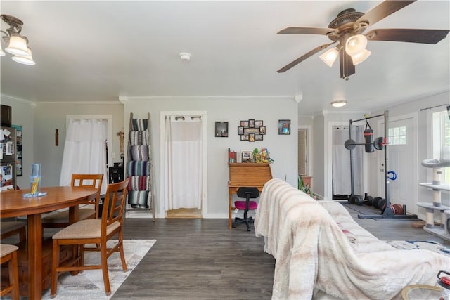 7848 Cold Springs Rd, Urbana, NY 14810 - dining area with ornamental molding, dark wood-style floors, ceiling fan, and baseboards