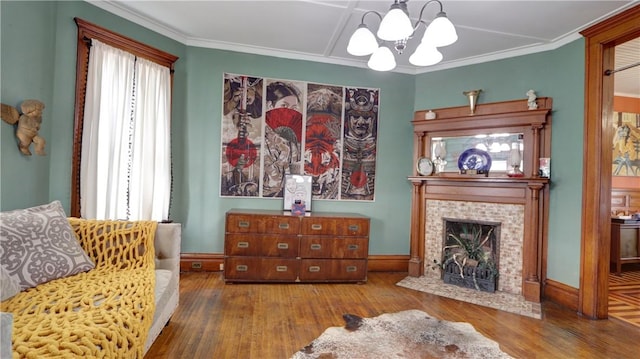 51 Sherrill St Unit 1, Geneva-City, NY 14456 - sitting room with wood finished floors, a chandelier, a tile fireplace, ornamental molding, and baseboards