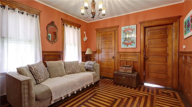 51 Sherrill St Unit 1, Geneva-City, NY 14456 - living room featuring a chandelier, healthy amount of natural light, a wainscoted wall, and crown molding