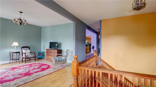 51 Sherrill St Unit 1, Geneva-City, NY 14456 - hallway with a chandelier, an upstairs landing, wood finished floors, and baseboards