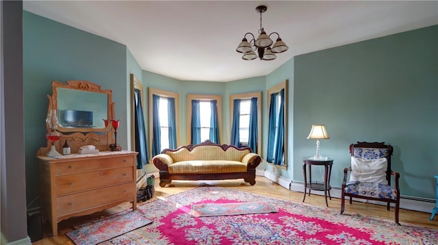 51 Sherrill St Unit 1, Geneva-City, NY 14456 - living area featuring a chandelier, wood finished floors, and baseboards