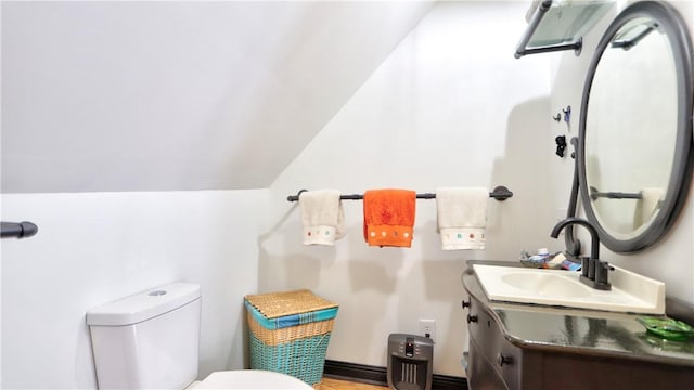 51 Sherrill St Unit 1, Geneva-City, NY 14456 - bathroom featuring toilet, vanity, wood finished floors, and vaulted ceiling