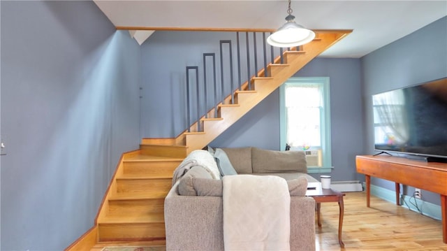 51 Sherrill St Unit 1, Geneva-City, NY 14456 - living room with stairway, wood finished floors, baseboards, and baseboard heating