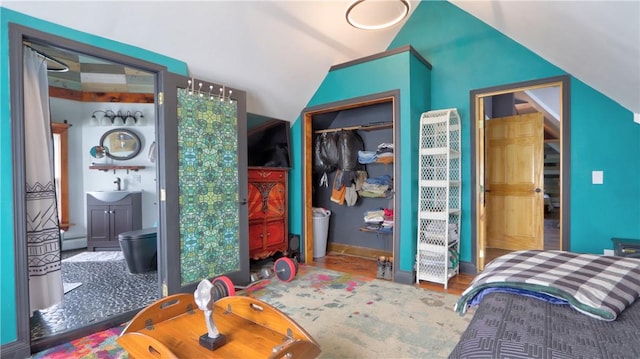 51 Sherrill St Unit 1, Geneva-City, NY 14456 - bedroom featuring lofted ceiling, wood finished floors, a sink, a closet, and baseboards