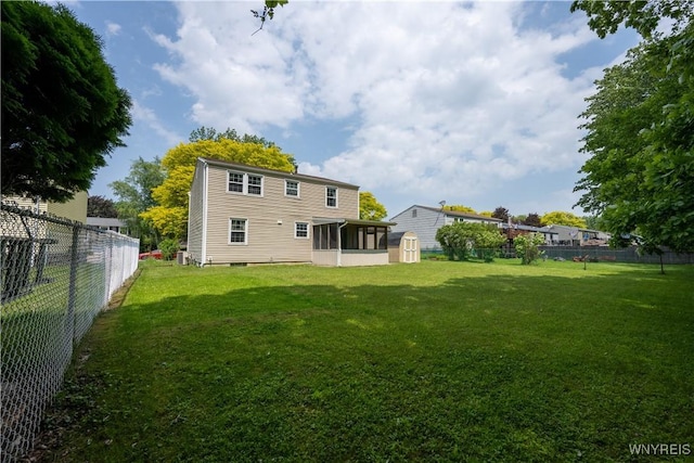 897 Fairmont Ave, North Tonawanda, NY 14120 - back of house with a storage shed, a fenced backyard, and a sunroom
